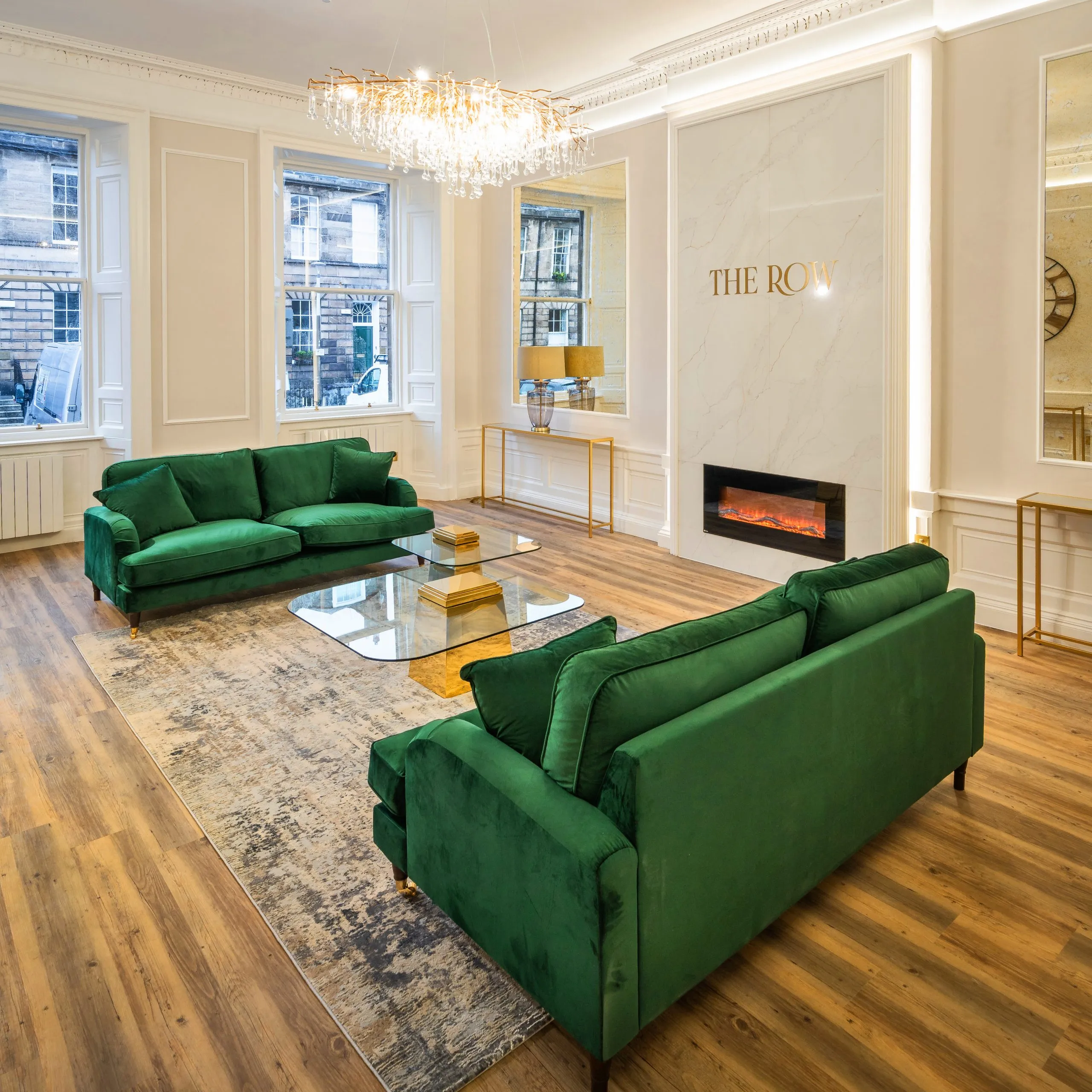 High-ceilinged patient lounge with feature fireplace at The Row dental clinic, Edinburgh