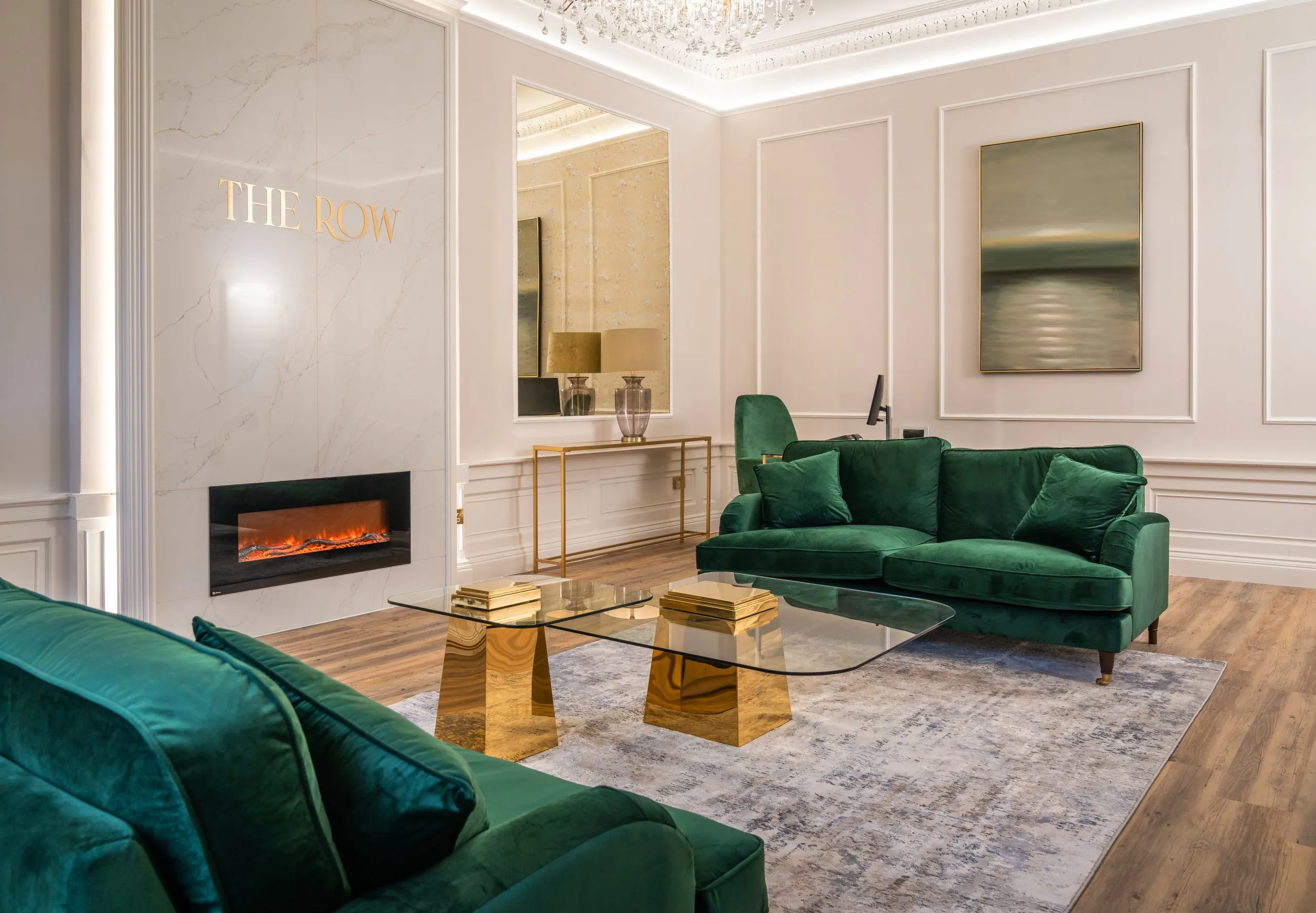 Patient lounge with emerald sofas and fireplace at The Row, Edinburgh — dental practice interior design