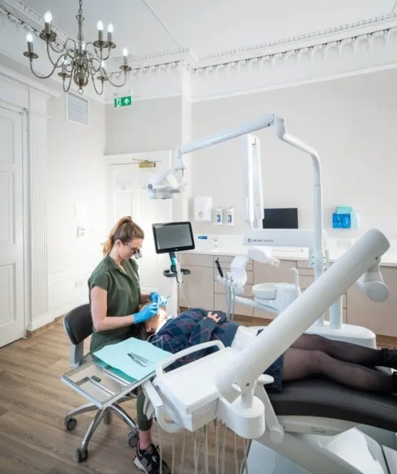 Dentist treating a patient in a completed surgery at The Row, Edinburgh