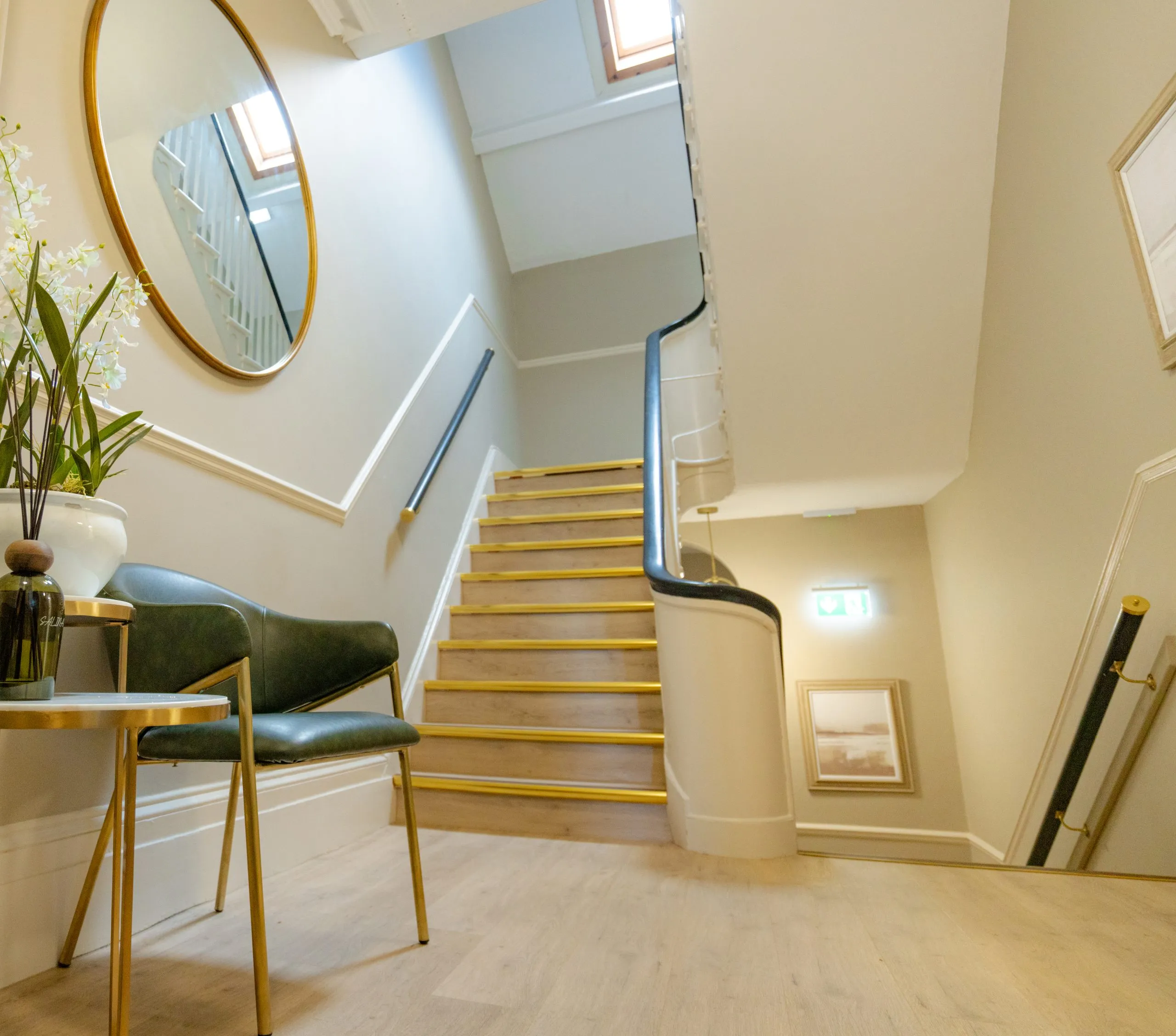 Refurbished staircase with brass handrail linking the three floors of Alma Dental, North Shields