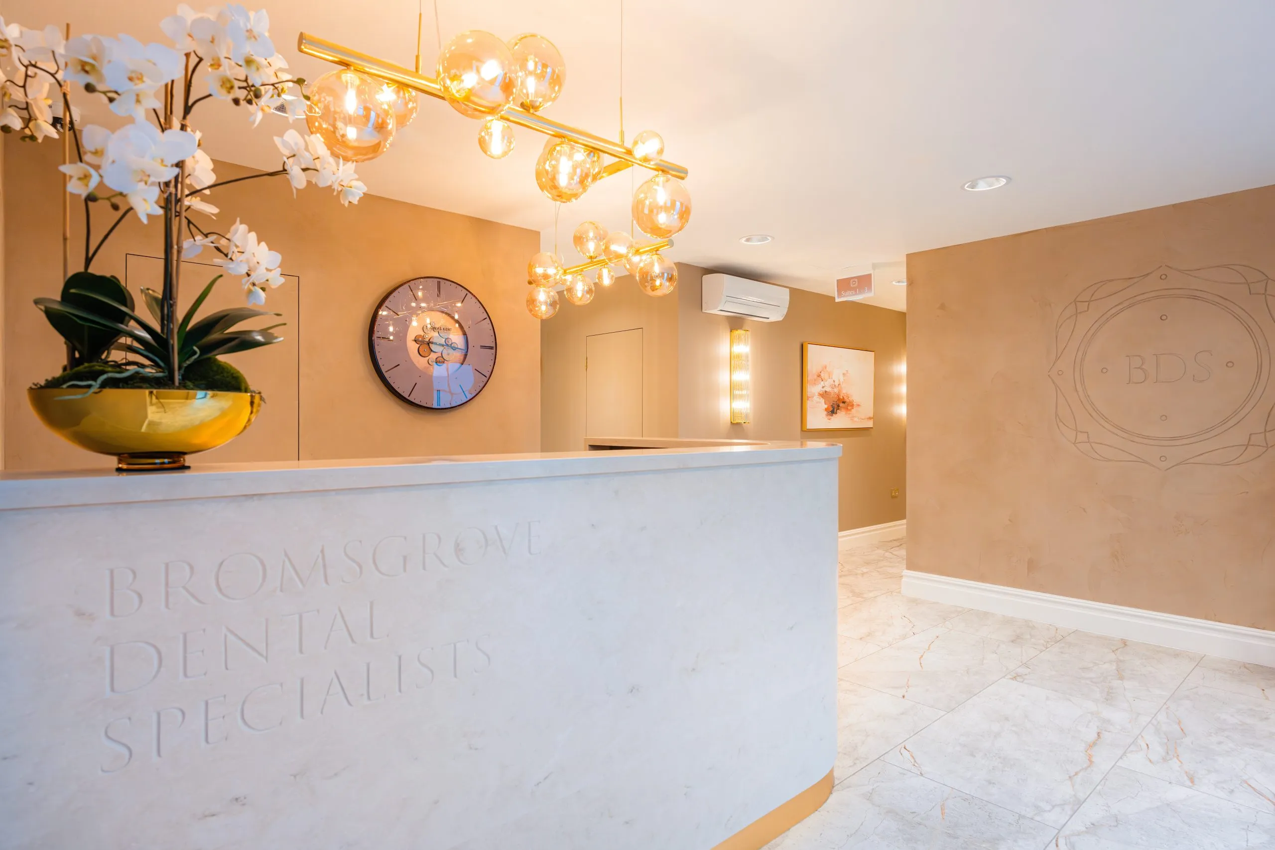 Bespoke stone reception desk with engraved branding at Bromsgrove Dental Specialists