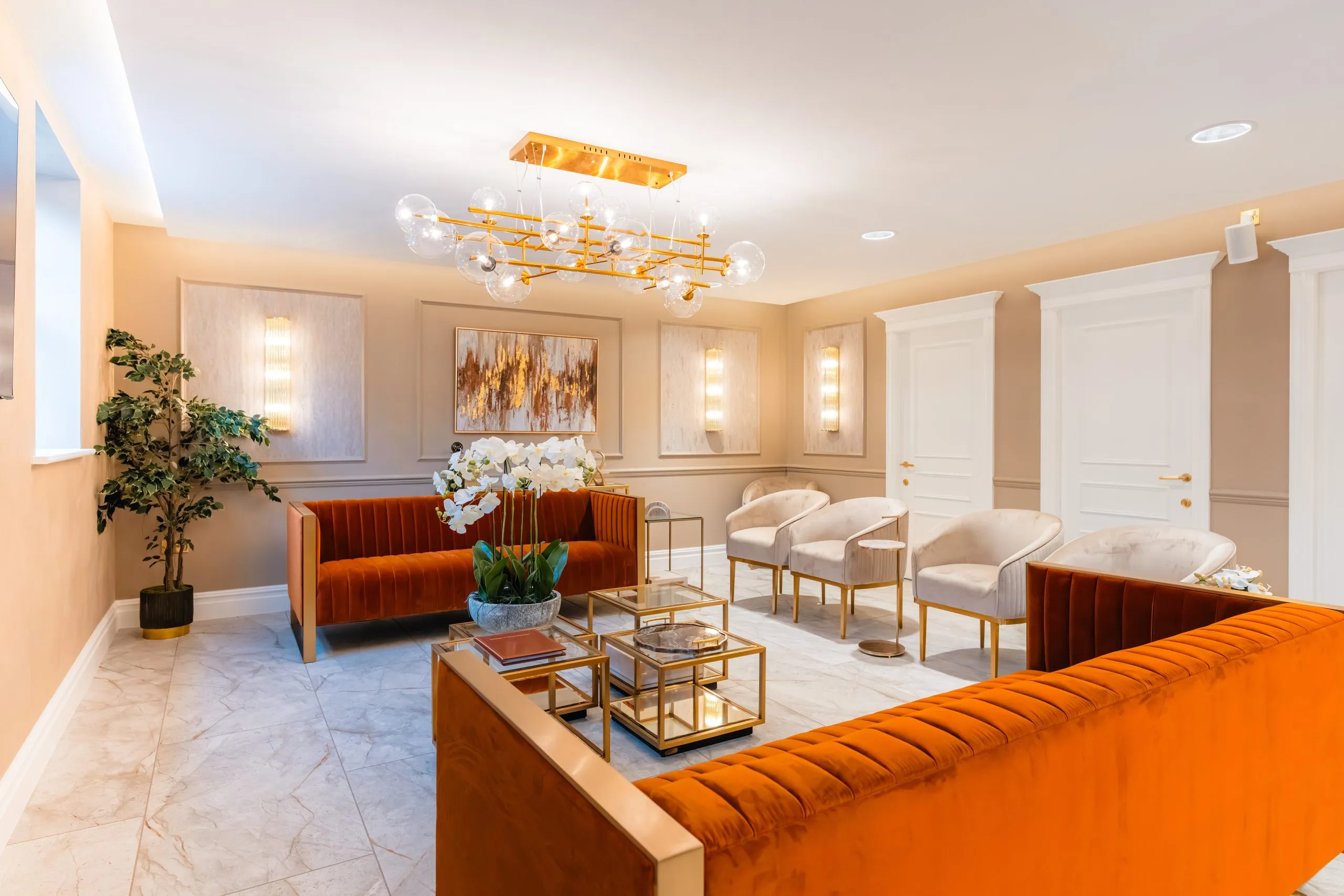 Burnt-orange velvet sofas in the waiting lounge at Bromsgrove Dental Specialists — dental practice design and build by BH Projects Group