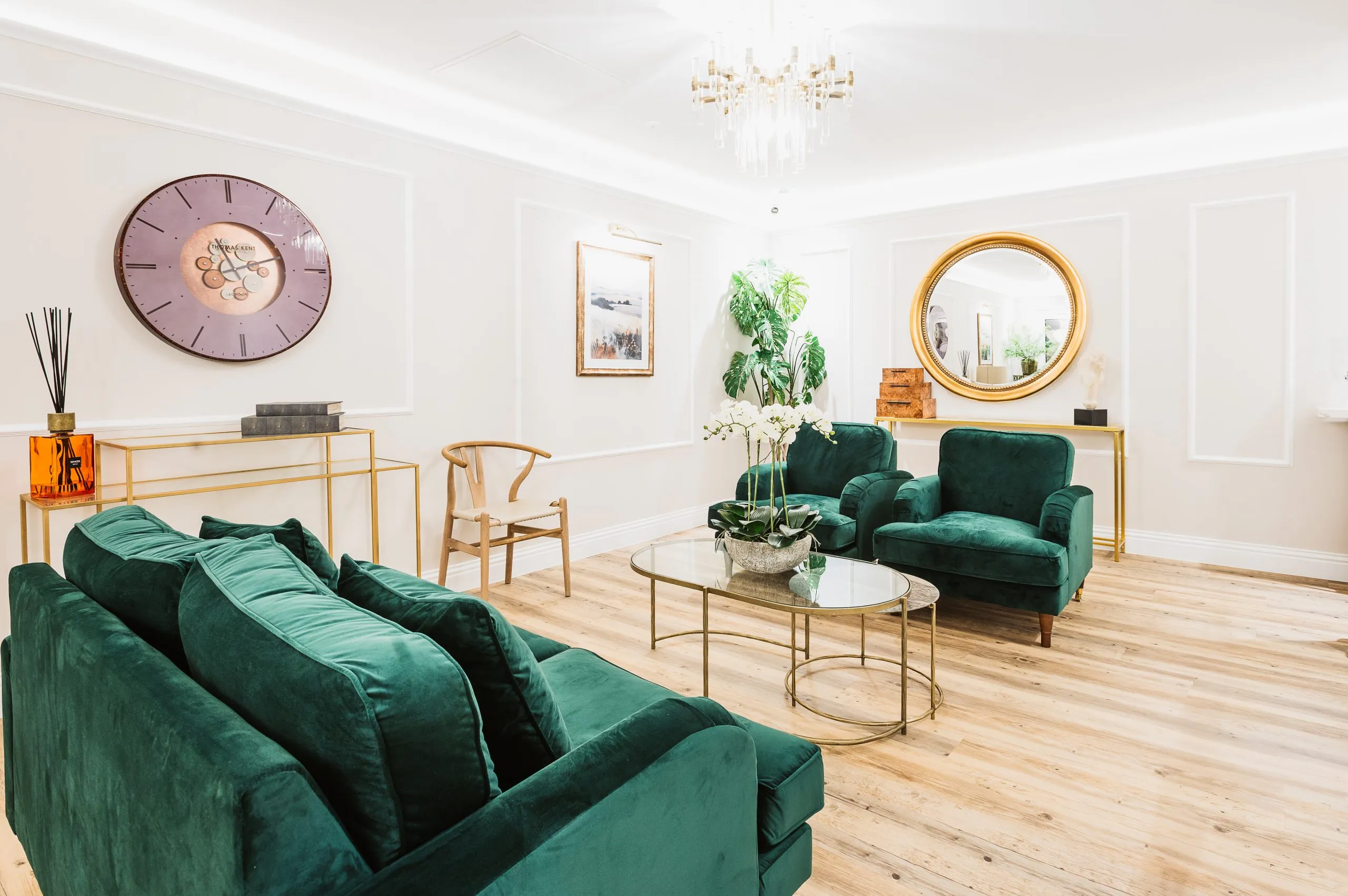 Emerald velvet sofas and gold mirror in the patient lounge at Bright Private Suite, Liverpool