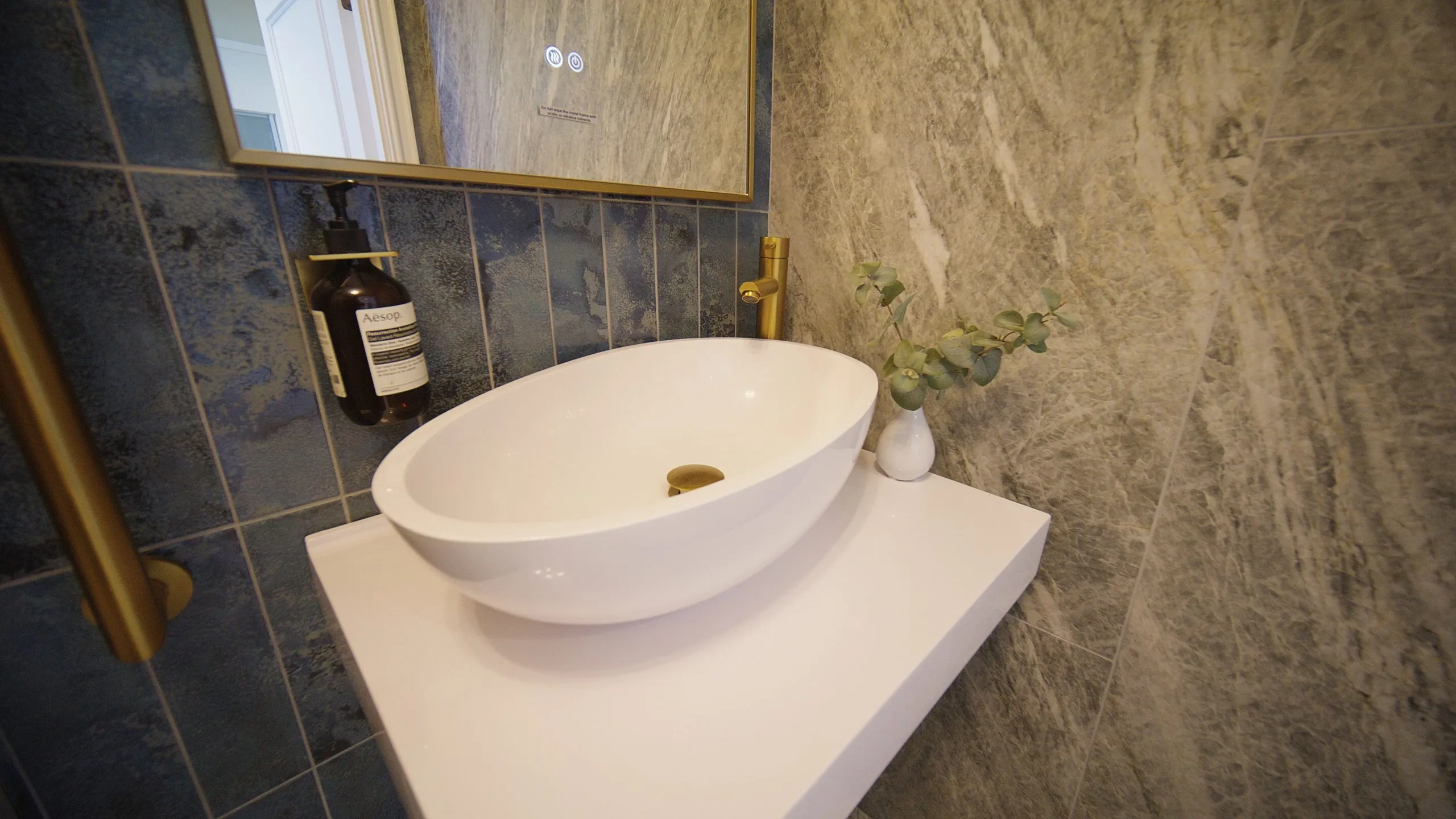 Marble-tiled washroom with countertop basin at Infinity Dental Suite, Harrogate