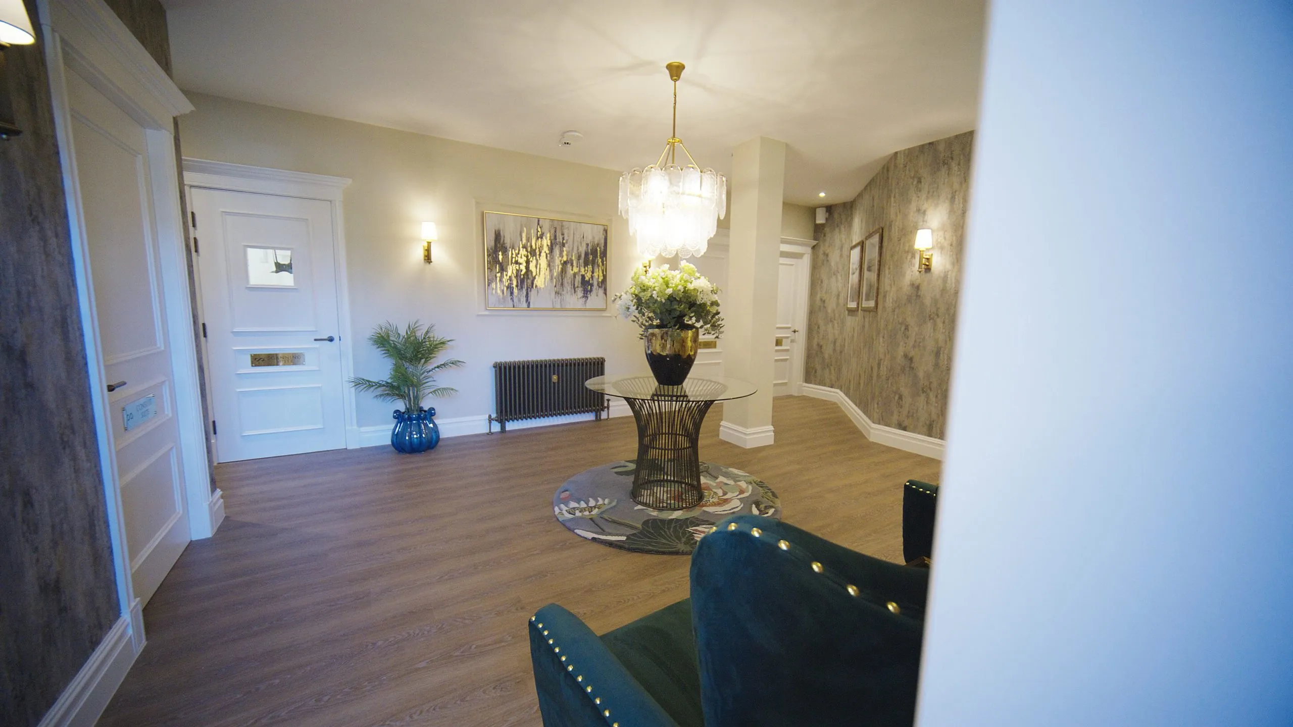 Hallway with chandelier and feature wall at Infinity Dental Suite, Harrogate