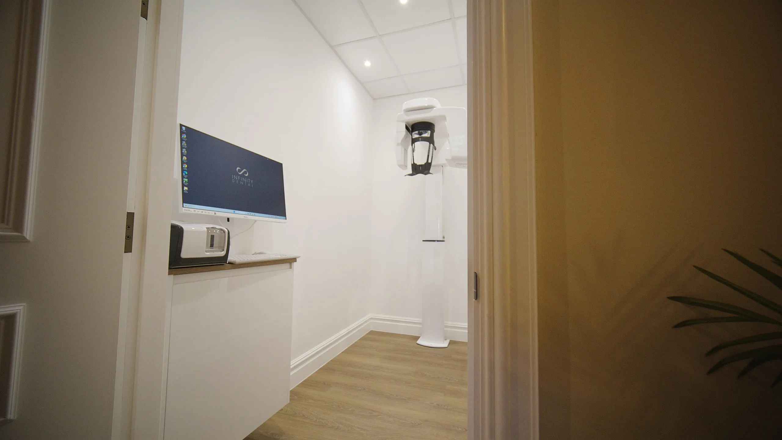 Corridor with wall-mounted X-ray unit at Infinity Dental Suite, Harrogate