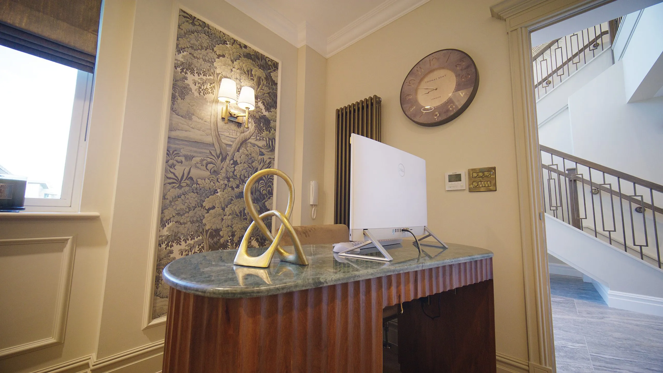 Granite-topped reception desk with botanical wallpaper at Infinity Dental Suite, Harrogate