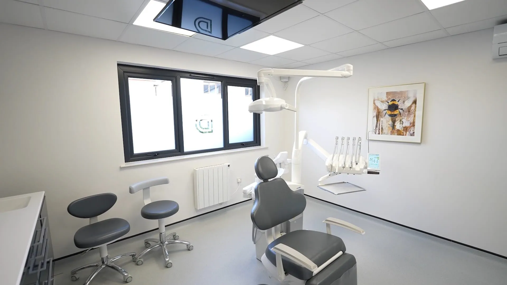 Dental surgery with clinician stools and overhead light at Durham Dental Implant Suite