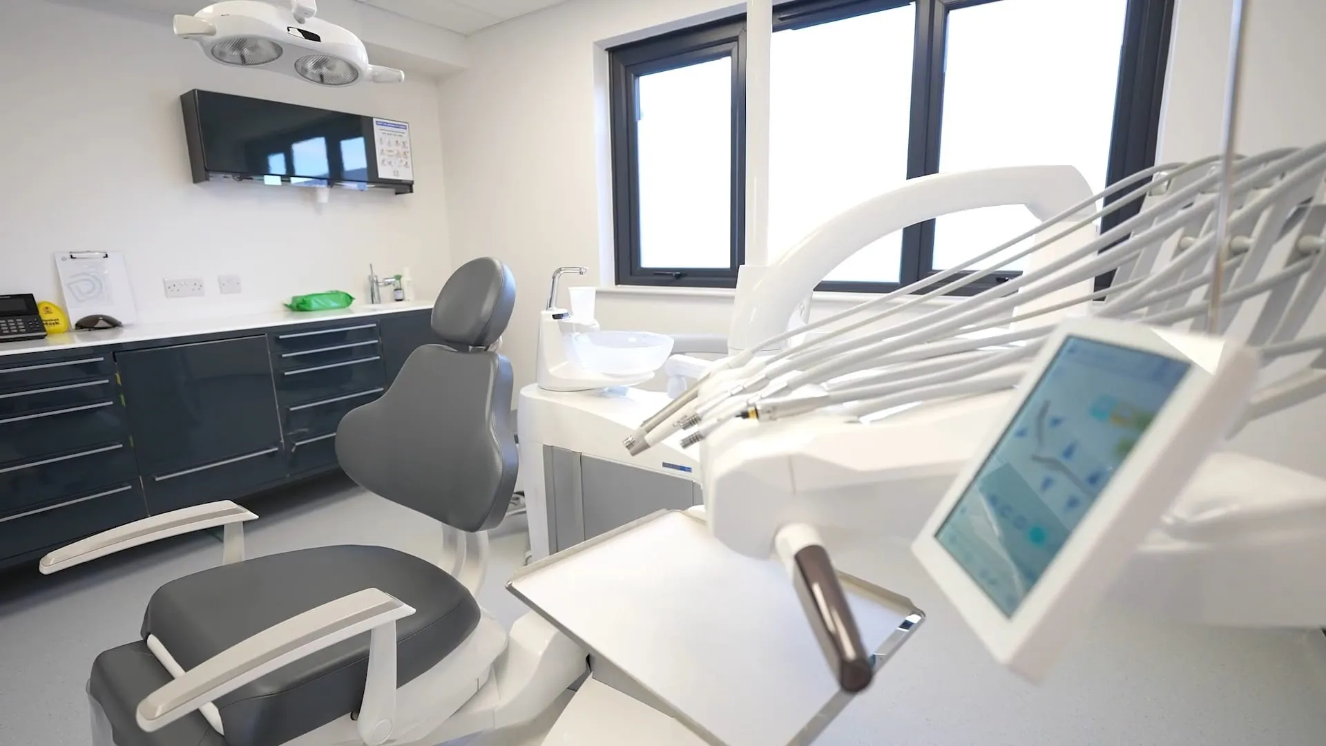 Implant surgery with dark cabinetry and new dental chair at Durham Dental Implant Suite