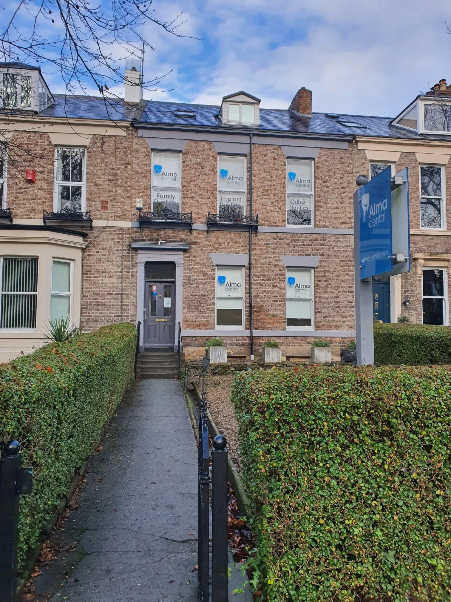 The Georgian townhouse before the refurbishment, with the practice's original blue signage
