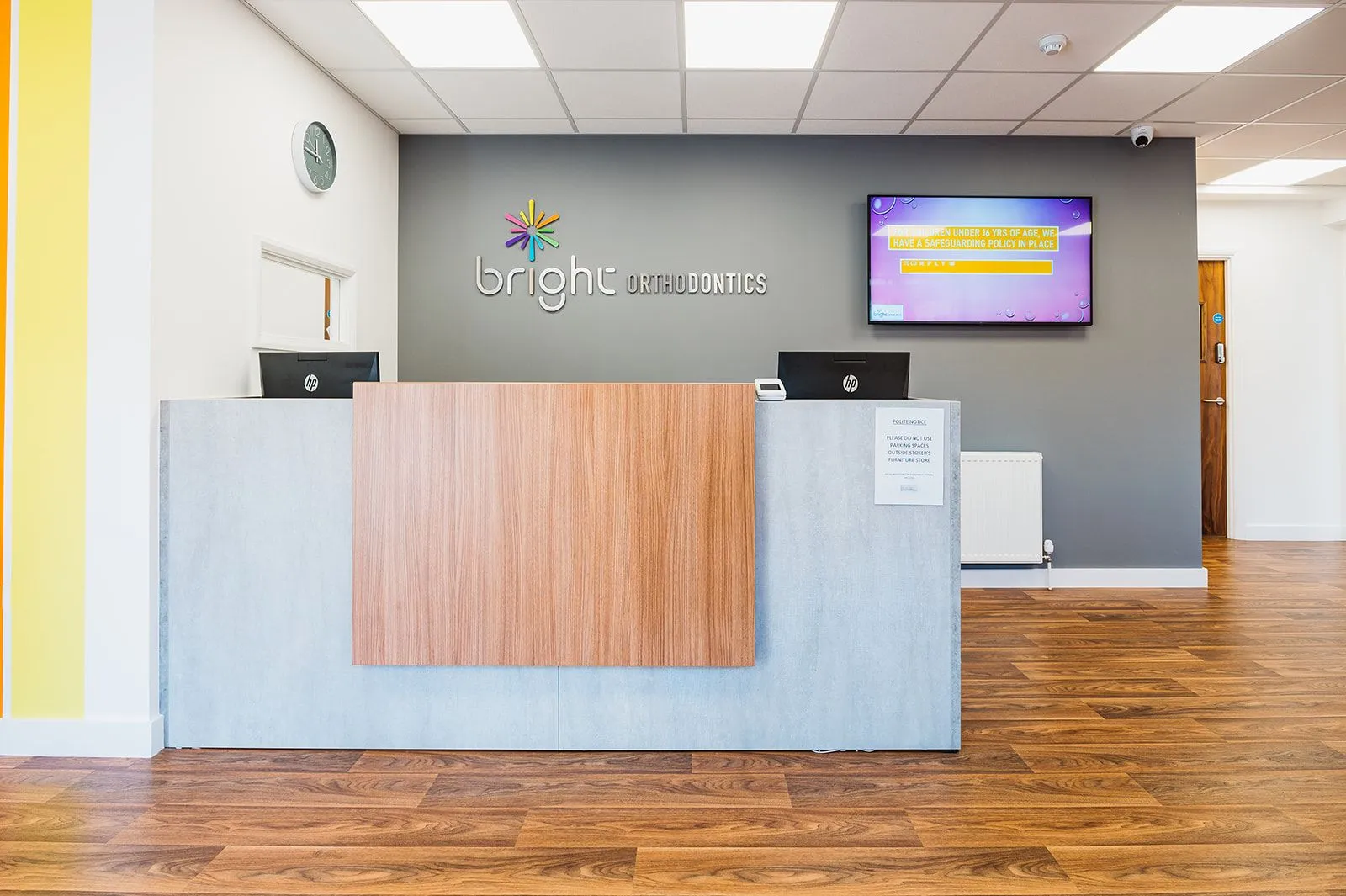 Timber reception desk and branded feature wall at Bright Orthodontics, Ormskirk