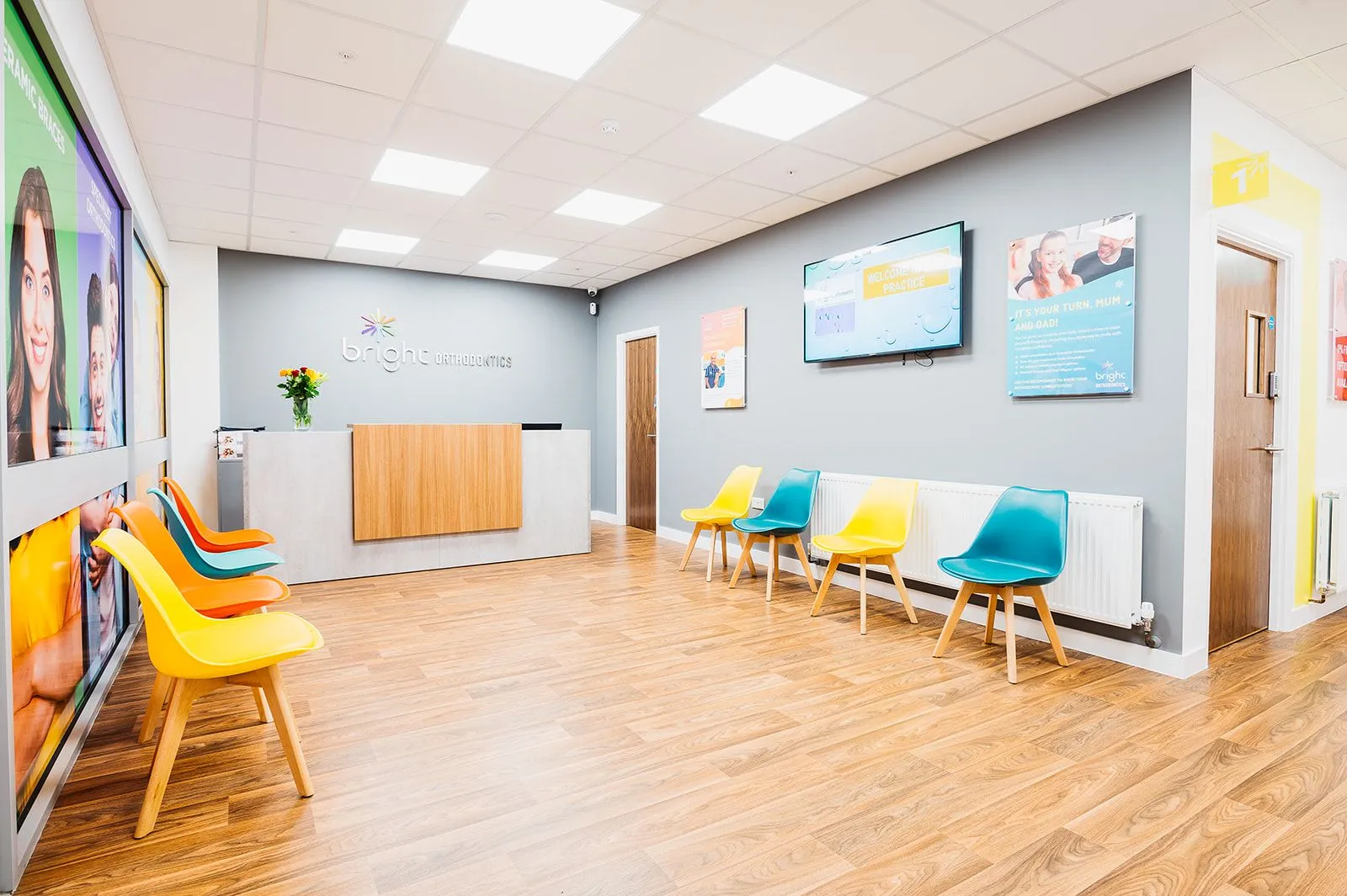 Waiting area with wall-mounted screens at Bright Orthodontics, Skelmersdale