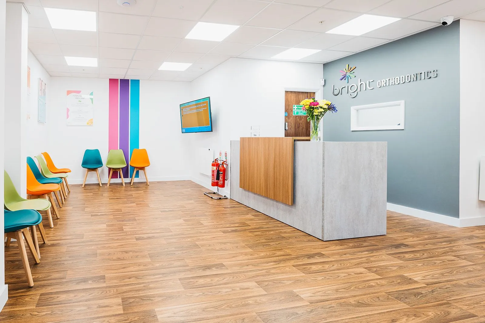 Timber reception desk and open waiting area at Bright Orthodontics, Warrington