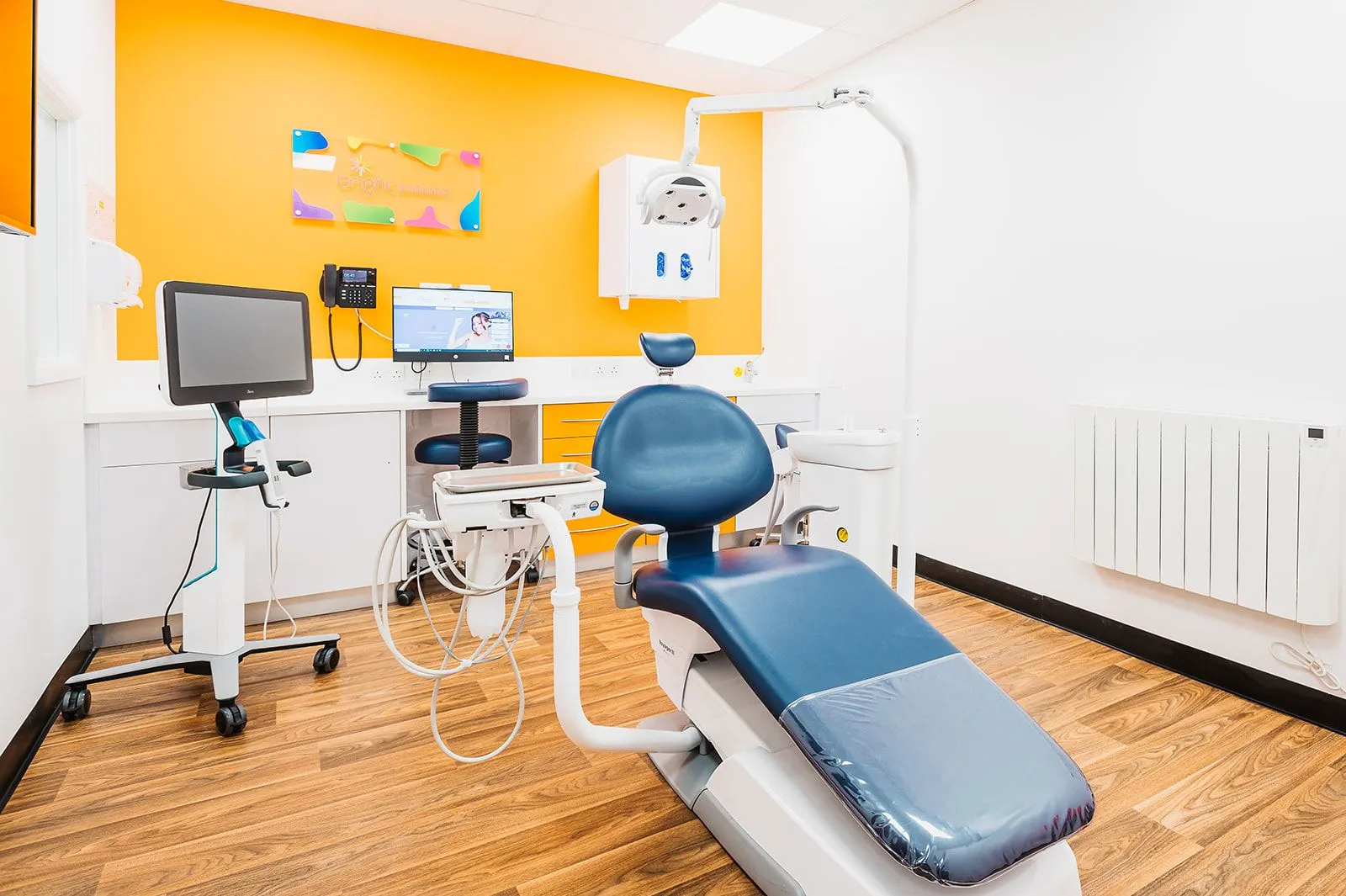 Orthodontic surgery with orange feature wall at Bright Orthodontics, Warrington