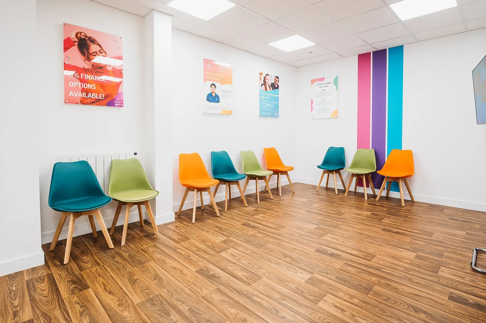 Waiting area with multicoloured chairs and branded artwork at Bright Orthodontics, Warrington