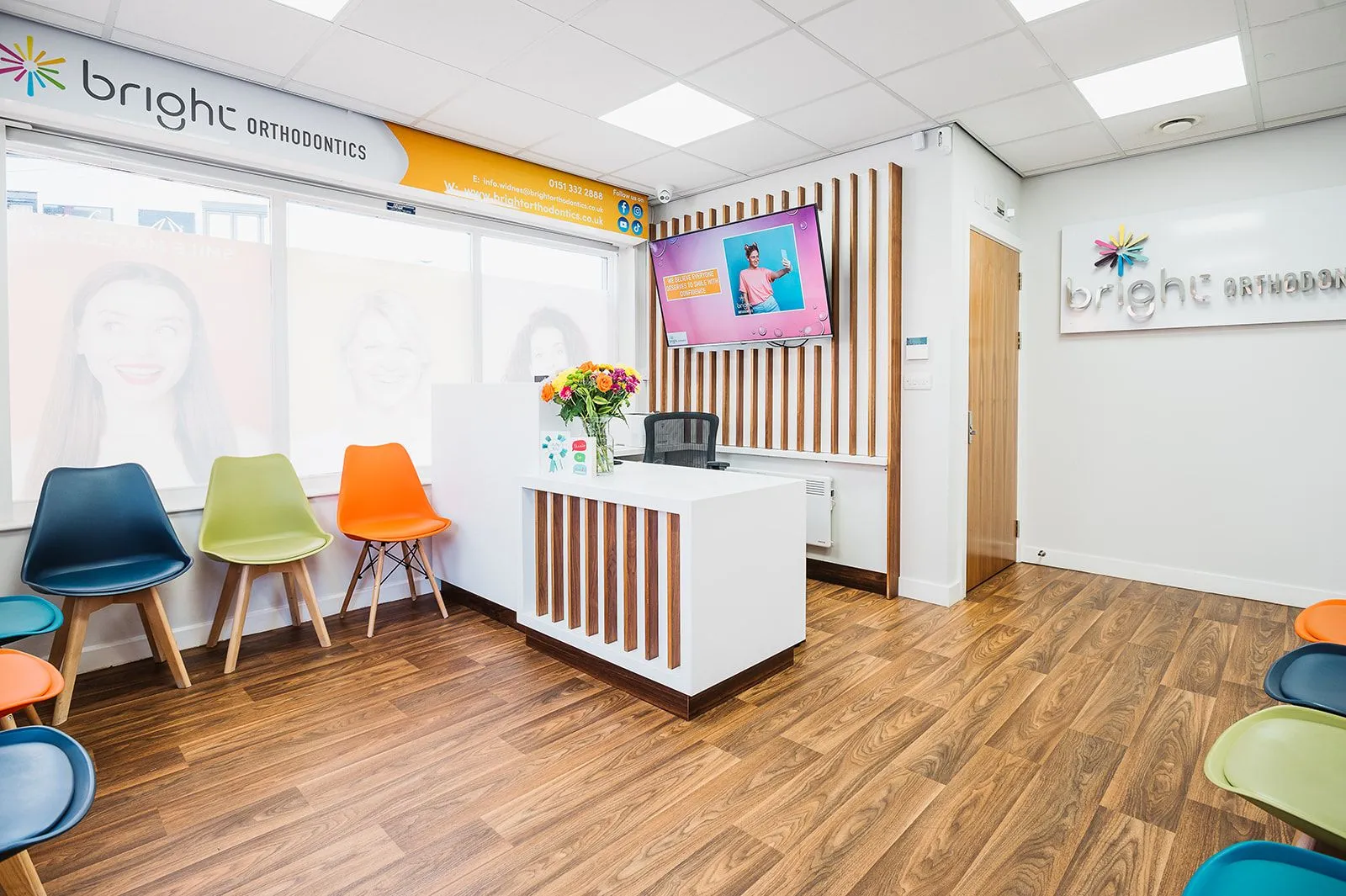 Reception desk with orange and green seating at Bright Orthodontics, Widnes