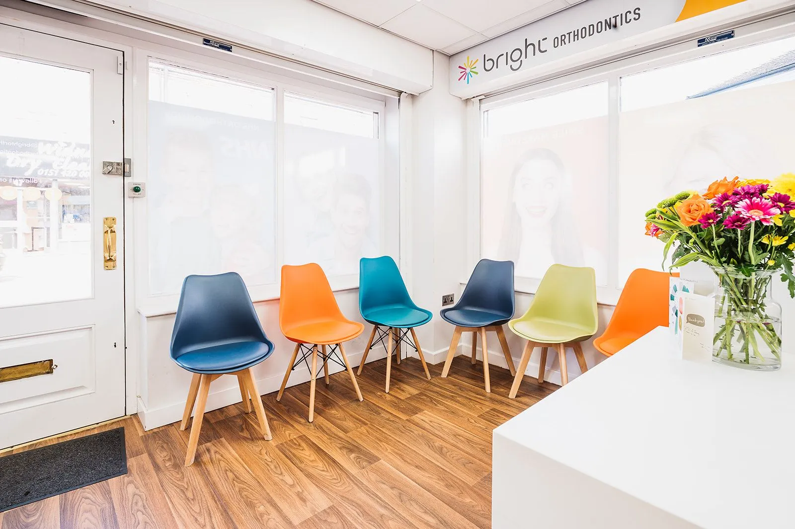 Bright waiting room with flowers and colourful chairs at Bright Orthodontics, Widnes